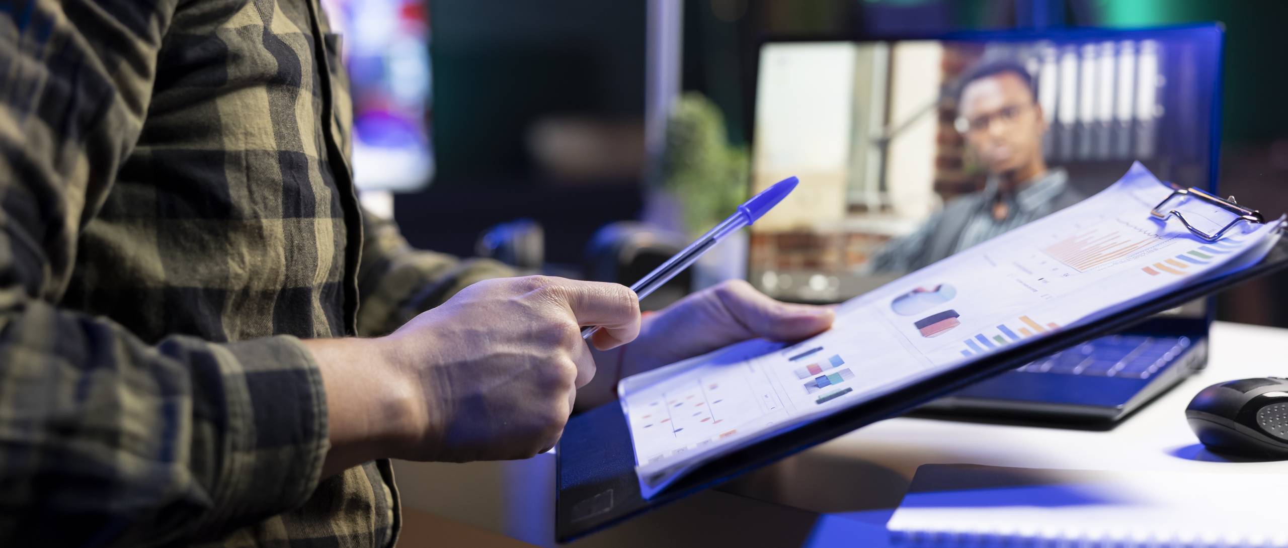Man reviews documents while on video call - website training