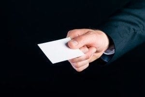 Business man or manager in suit hand over empty business card to