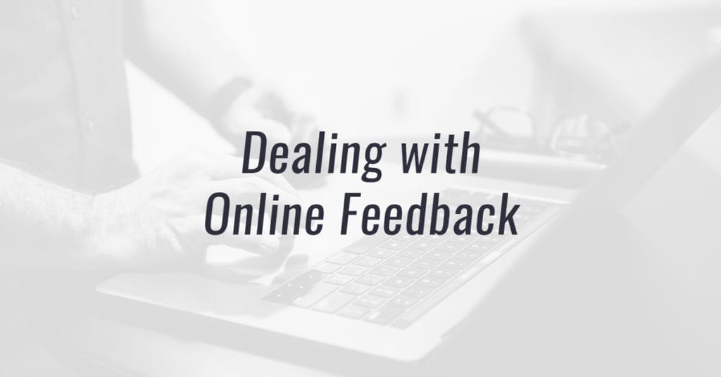 Image of a person at a laptop computer with text reading "Dealing with Online Feedback"