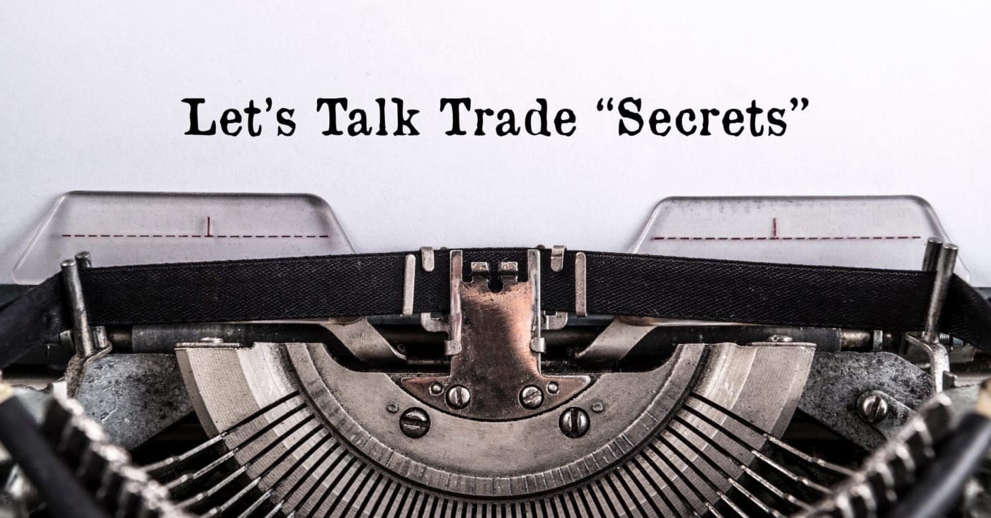 Photo of a typewriter with text reading "Let's Talk Trade Secrets"