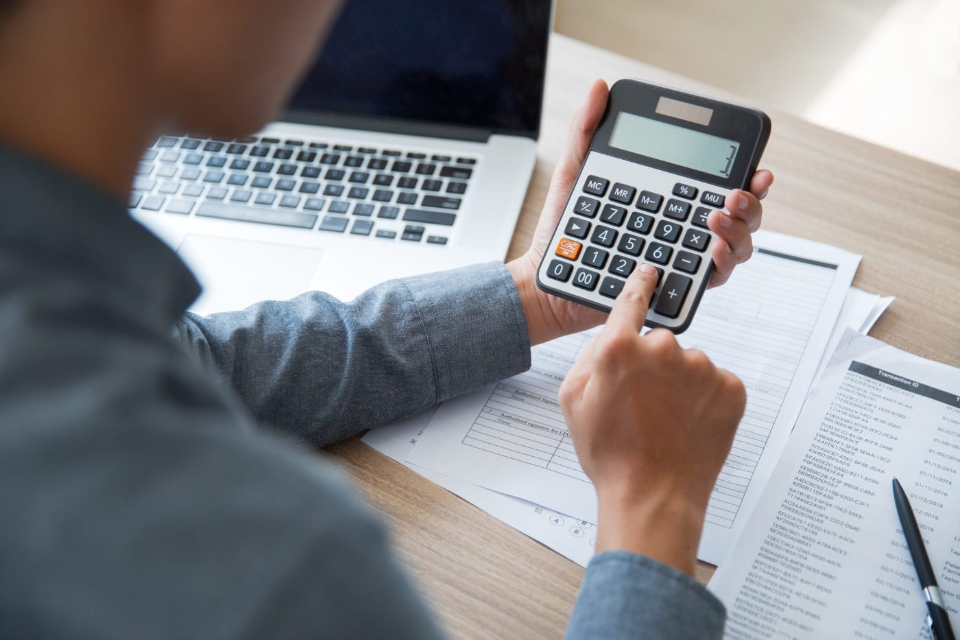 Man using calculator for finances